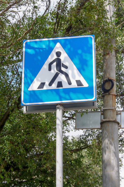 Road sign of a pedestrian crossing on the street