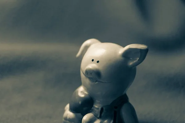 Sculpture of a toy pig on a blue background