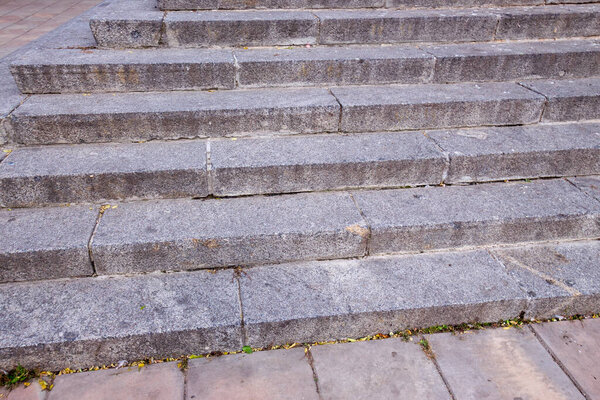 Granite old stairs in the park in the city