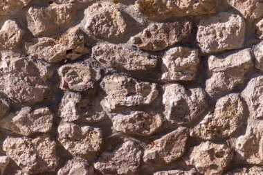 Arkaplan için büyük kırmızı taşlardan oluşan taş duvar