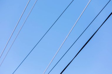 Mavi gökyüzünün arka planında elektrik hatları
