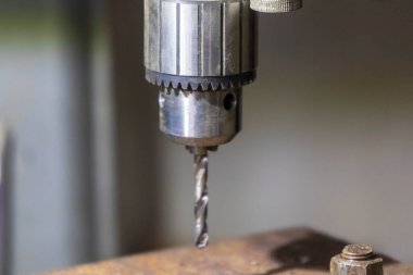 Delme makinesi çalışıyor. Usta atölyede atölye çalışması yapar.