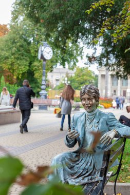 Parktaki bankta oturan bir iş kadınının anıtı.