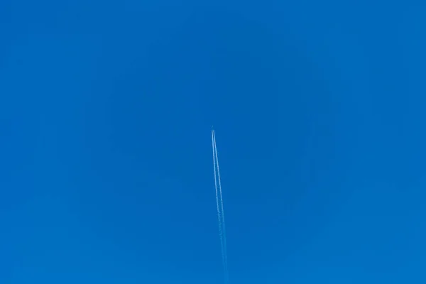 飞机停在蓝天上 留下一条白色的小径 — 图库照片