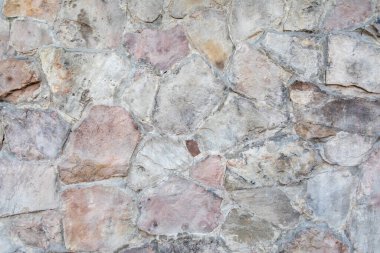 Gri ve kırmızı büyük taştan yapılmış taş bir duvarın dokusu