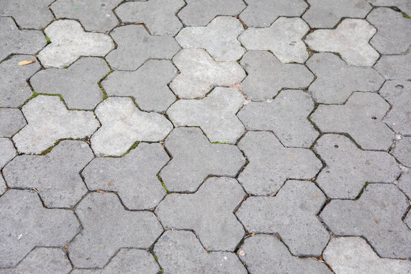Texture of gray cobblestones in the park. Pavement for backgrounds