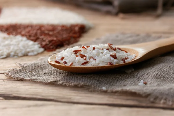 White and red rice in a wooden spoon — Stock Photo, Image