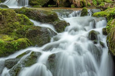 Waterfall on a mountain stream in spring. Vosges, France, Europe.