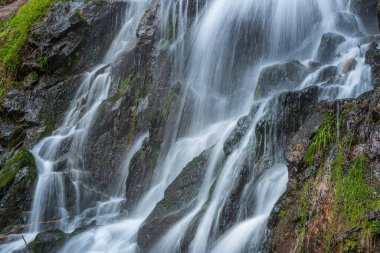 Waterfall on a mountain stream in spring. Vosges, France, Europe.