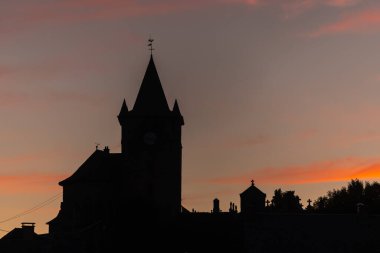 Gün batımında Laguiole 'deki St. Mathieu Kilisesi' nin silueti. Laguiole, Aubrac, cevennes, Fransa.