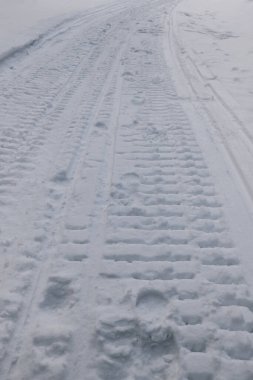 Karda kızışmış bir kar aracının yakın çekimi. Kışın açık hava eğlencesi. Ayak izlerinin seçici odak noktası