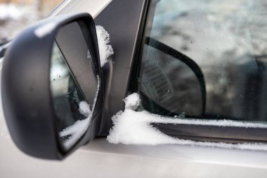 İnceleme için arabanın yan aynası. Karlı hava, kış mevsimi.
