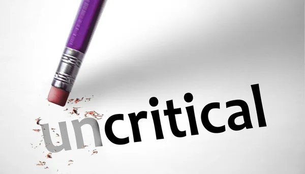 Eraser changing the word Uncritical for Critical — Stock Photo, Image