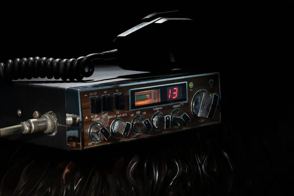 Old CB radio with microphone on top tuned into channel 13