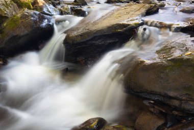 Stream water cascading between boulders near Boone North Carolina after sunset