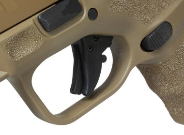 Trigger on a semi automatic pistol with magazine release behind