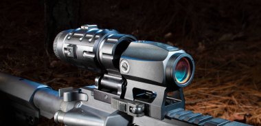 Magnifier behind a rifle'sred dot sight in the field