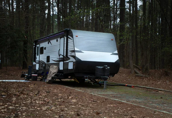 Camping trailer that is whte with black and gray at Jordan Lake in North Carolina