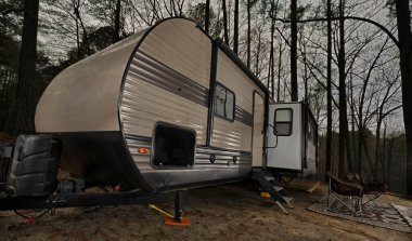 Bumper pull trailer at a campsite in North Carolina as the sun sets