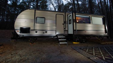 Trailer as night falls in a forest near Jordan Lake in North Carolina