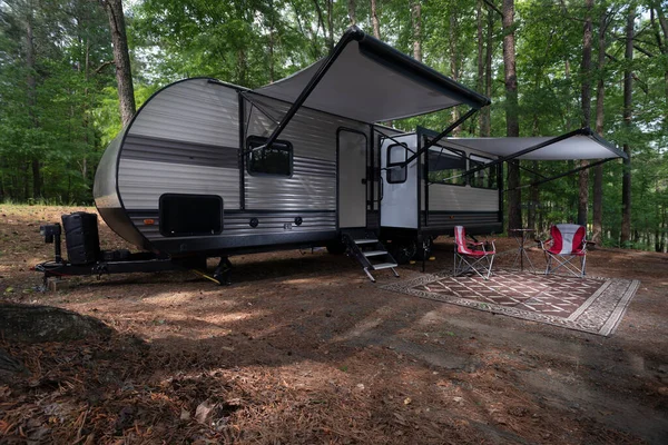 Travel trailer set up with awnings out at a campsite at Jordan Lake North Carolina