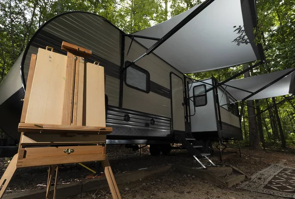 Painting easel next to a camping trailer at Falls Lake in North Carolina