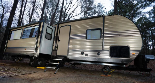 Camper trailer in a daytime forest near Jordan Lake in North Carolina