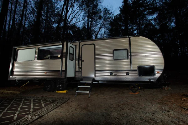 Night travel trailer in a forest near Jordan Lake in North Carolina