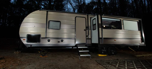 Camping trailer at night in a forest near Jordan Lake North Carolina