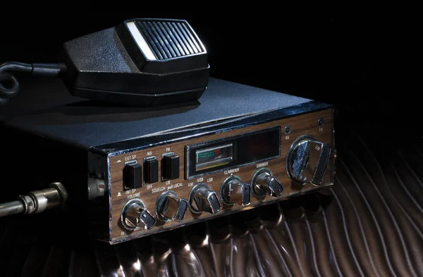 CB radio with mike that run on sideband on wavy bronze table