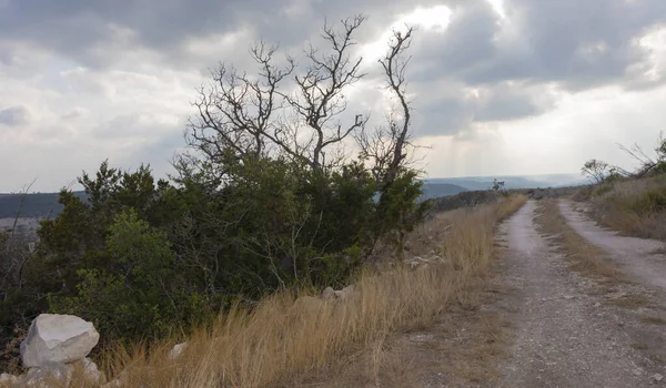 Remote trail in Texas Hill Country with storm moving in