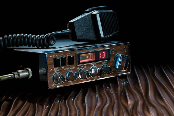 Sideband CB radio set to channel 13 on a wavy bronze surface