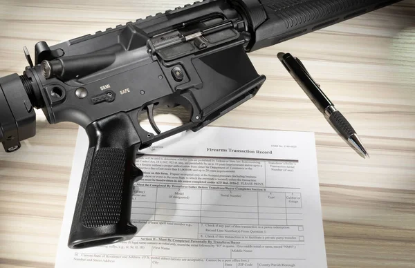 Firearm purchase background check form in public domain with an assault rifle
