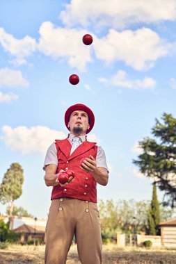 Adam parkta top çeviriyor.