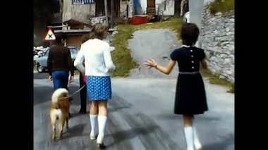 milan,italy june 10 1970:people walking in a 70's country