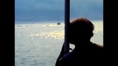liguria, italy june 10 1980:woman on a boat at the harbor during 80's vacation