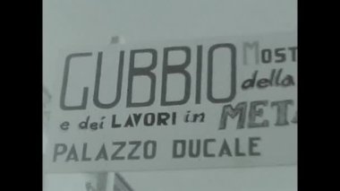 gubbio, italy may 1960 : sign in gubbio indicating village festival in black and white in the 60s