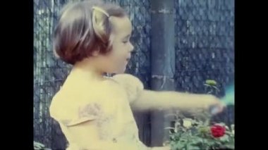 ravello, naples june 1960: little girl plays with the ball in the garden in the 60s
