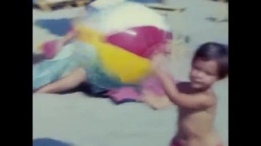 ravello, naples june 1960: little girl plays on the beach by the sea in Ravello with ball in the 60s