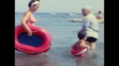 ravello, naples june 1960: mother and daughter play in the water at the sea of Ravello in the 60s