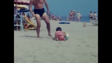 ravello, naples june 1960: little girl plays on the beach by the sea in Ravello with ball in the 60s