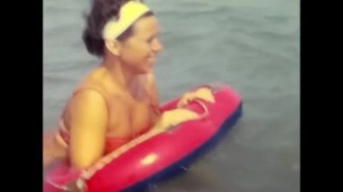 ravello, naples june 1960: mother and daughter play in the water at the sea of Ravello in the 60s