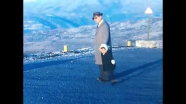 ravello, naples april 1960: man and girl in the mountains with 60s landscape