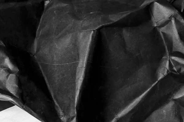 黒のしわの多い紙の背景グランジの質感の背景 — ストック写真