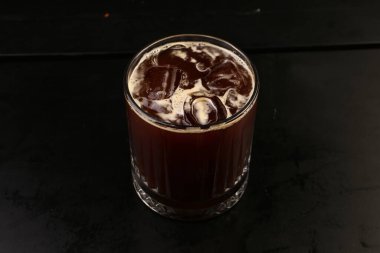 Sütlü buzlu kahve. Buzlu kahve. Elinde bir bardak buzlu kahve tutan kadın..