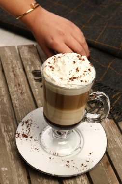 Sütlü buzlu kahve. Buzlu kahve. Elinde bir bardak buzlu kahve tutan kadın..
