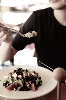 çekici beyaz salata, odak üstünde el yemek kadın ve çatal gülümseyen portresi.
