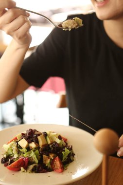 çekici beyaz salata, odak üstünde el yemek kadın ve çatal gülümseyen portresi.
