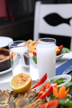 Özel Alkollü İçkili Rakılı Türk ve Yunan Geleneksel Yemek Masası. Uzo ve Türk Rakısı, Türkiye, Yunanistan, Kıbrıs ve Lübnan'da yaygın olarak tüketilen kuru anason aromalı bir aperatiftir.