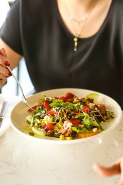 çekici beyaz salata, odak üstünde el yemek kadın ve çatal gülümseyen portresi.